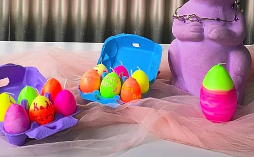 Brightly colored eggs in cartons, with purple rabbit.