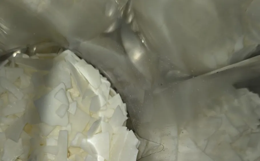 White flakes in a reflective metal container.