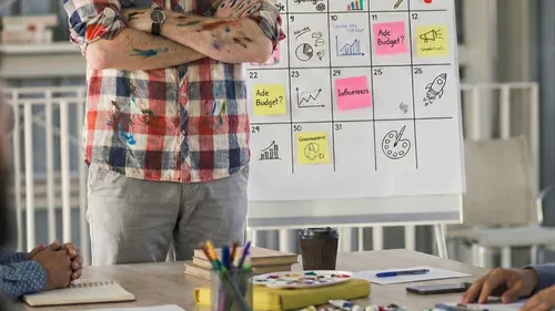 Person standing in front of illustrated planner.