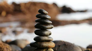 Stacked stones balanced on the beach.