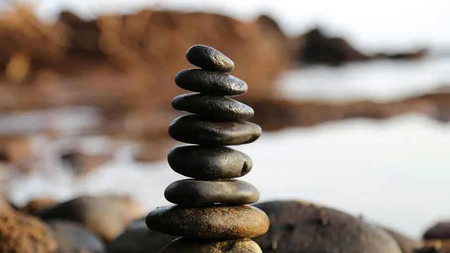 Stacked stones balanced on the beach.
