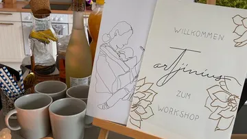 Kitchen setup with art workshop sign displayed.