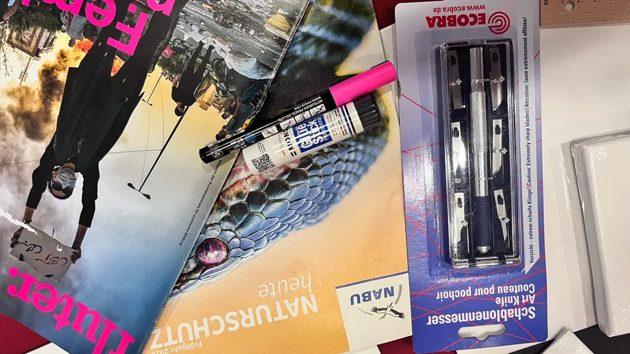 Stationery on magazines on a table.