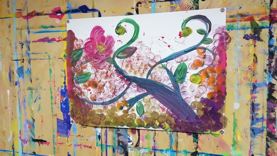 Abstract flower painting on colorful wall.