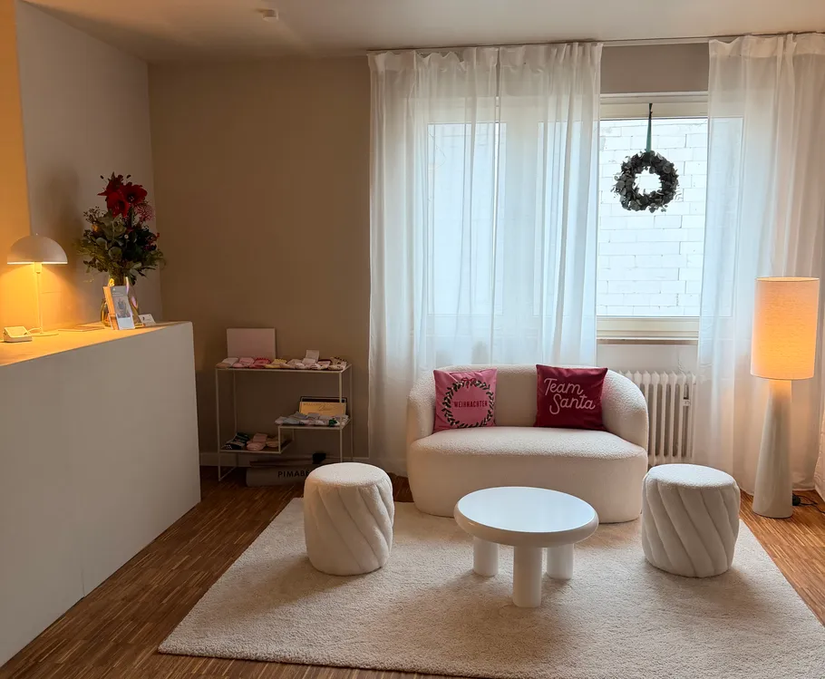 Cozy living room with white furniture and decor.
