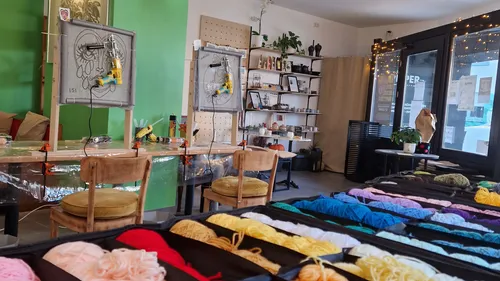 Workshop with yarn and crafting stations.