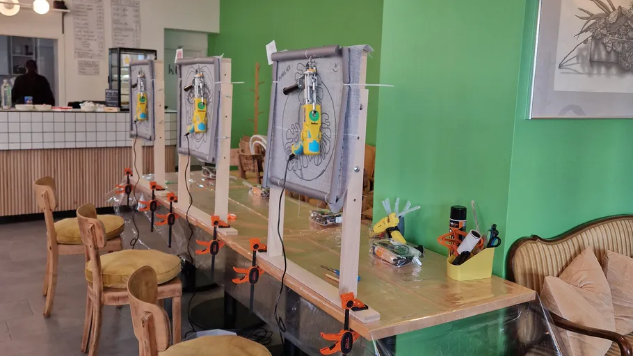 Art setup with wooden frames in a cafe.