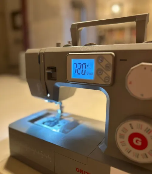 Sewing machine with digital display in room.