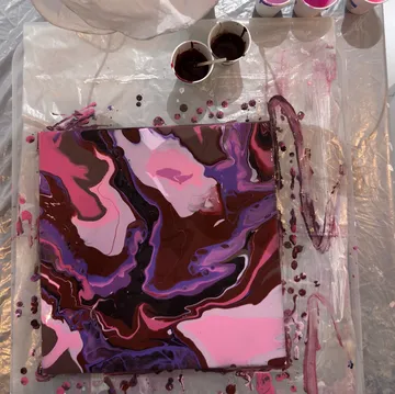 Abstract painting with swirling pinks and browns.