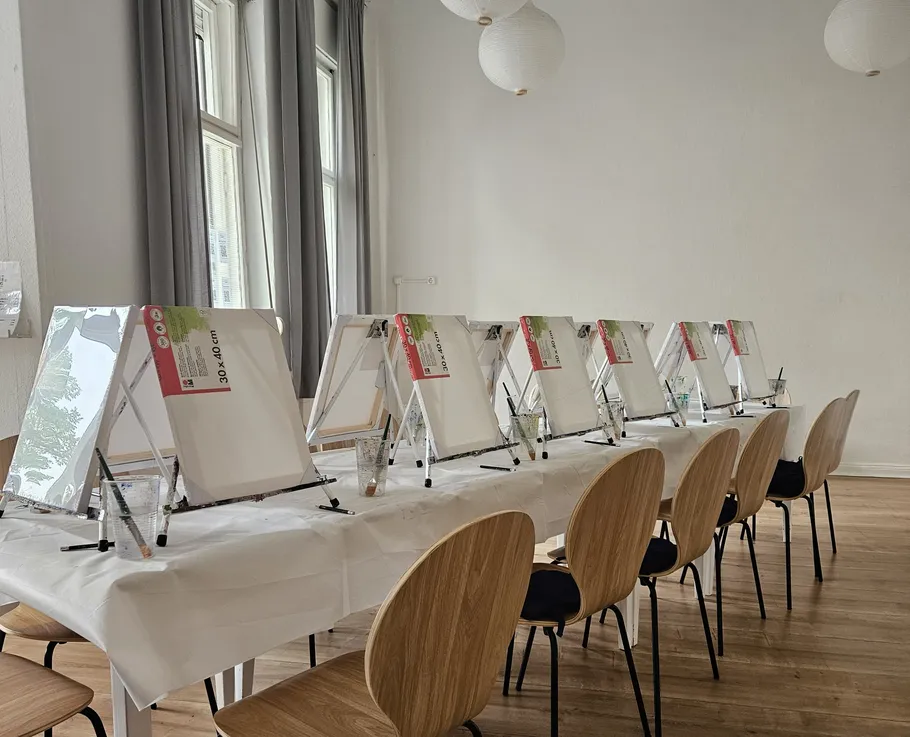 Art workshop setup with easels and chairs.