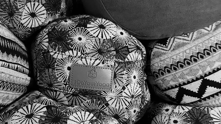 Patterned yoga pillows stacked together.