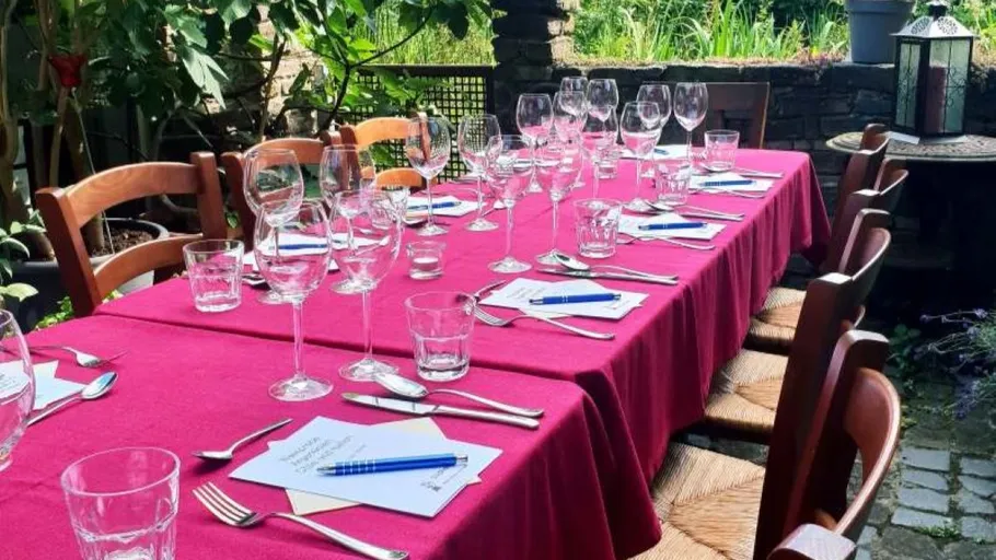 Table set with red cloth in garden.