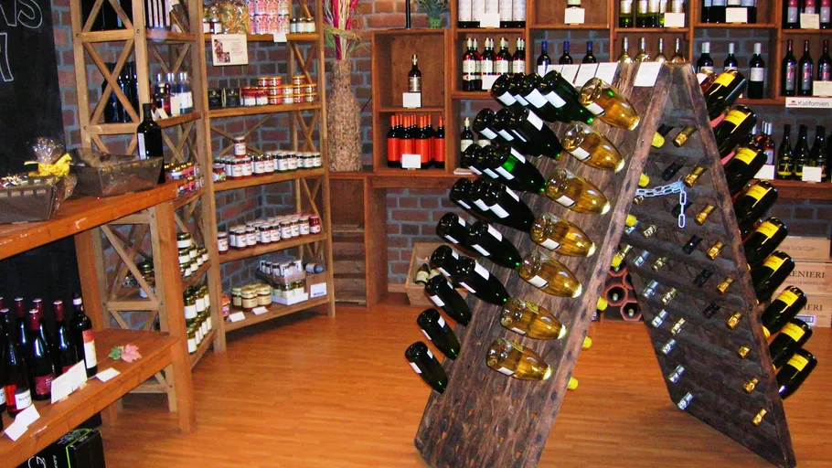 Wine bottles displayed in a rustic shop.