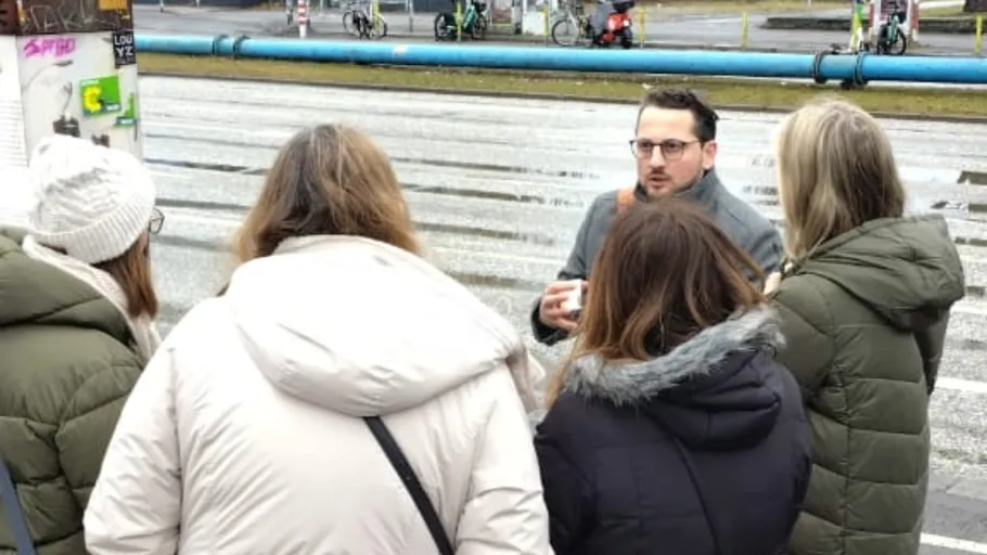 Group of people talking on a street.