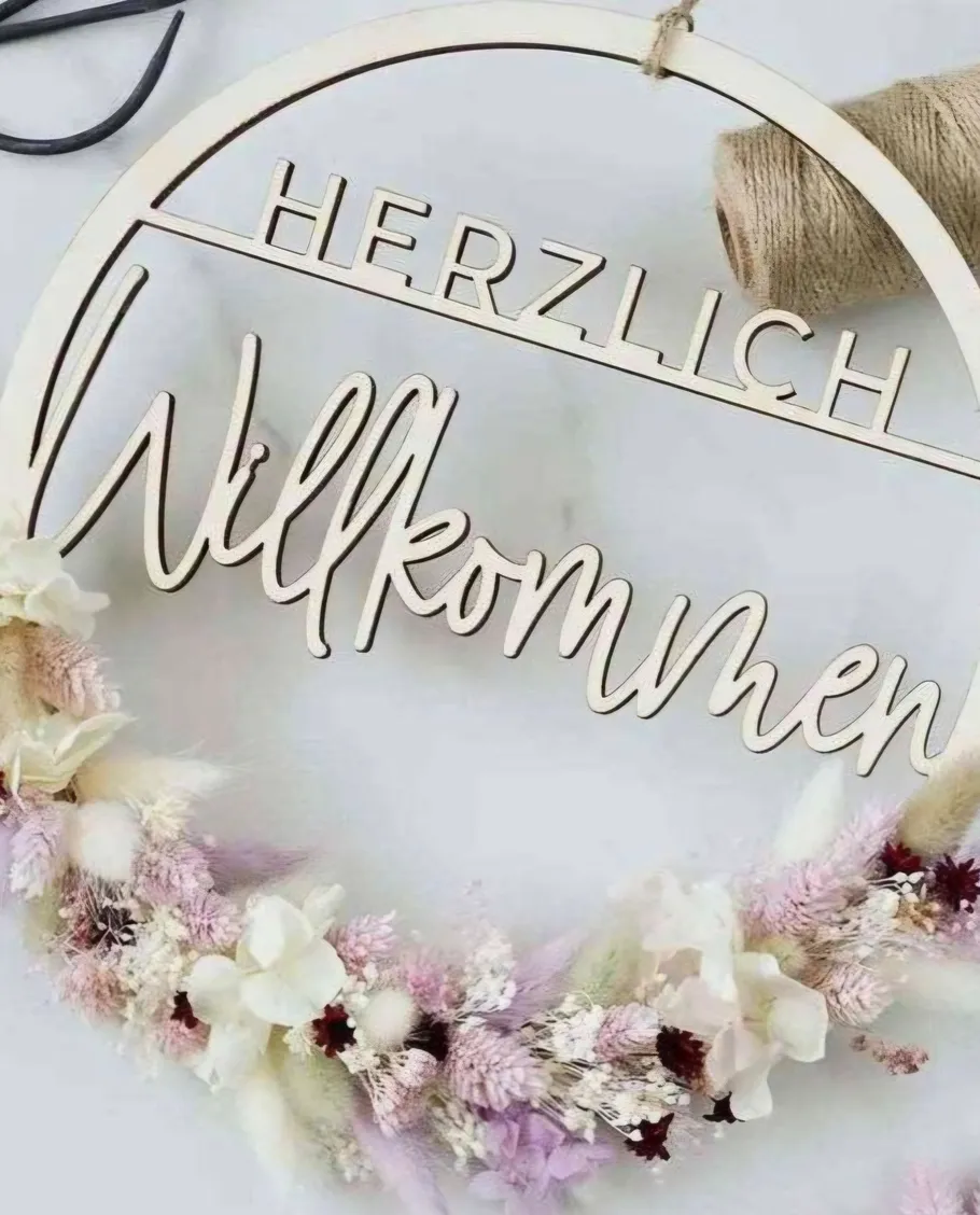 Wooden welcome sign with floral wreath.