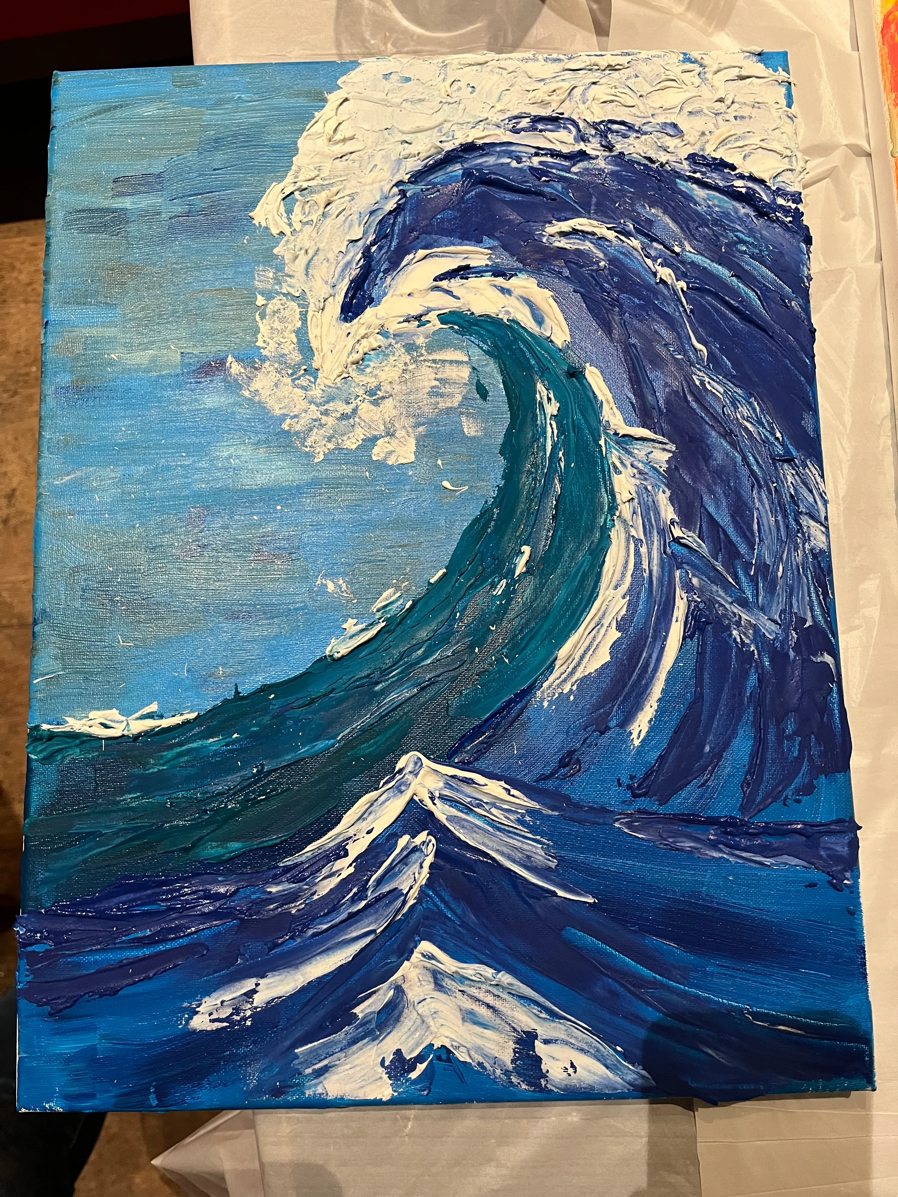 Abstract painting of a large ocean wave.