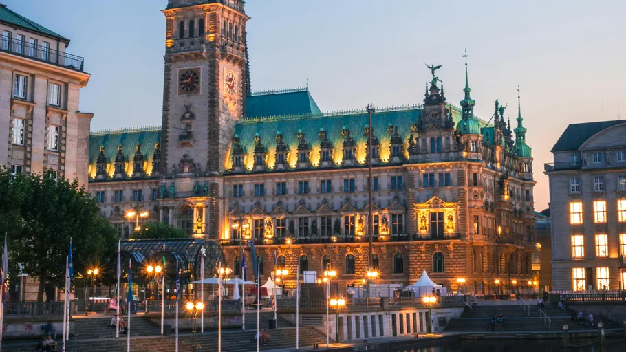 Illuminated historic building at dusk, urban setting.