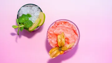 Two cocktails on a pink background.