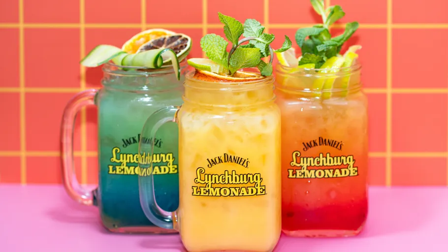 Three colorful lemonades in branded mason jars.