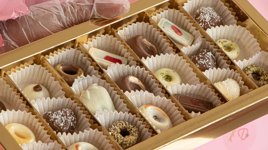 Assorted chocolates in a golden box.