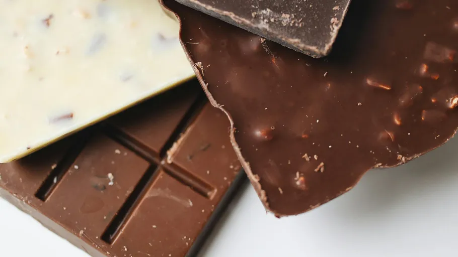 Three chocolate bars stacked closely together.