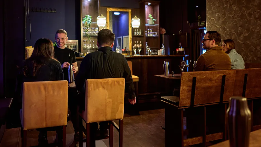 People socializing at a cozy bar.