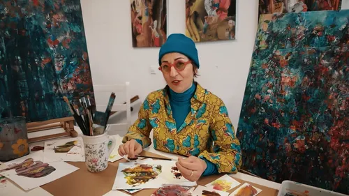 Woman painting in vibrant colored studio.