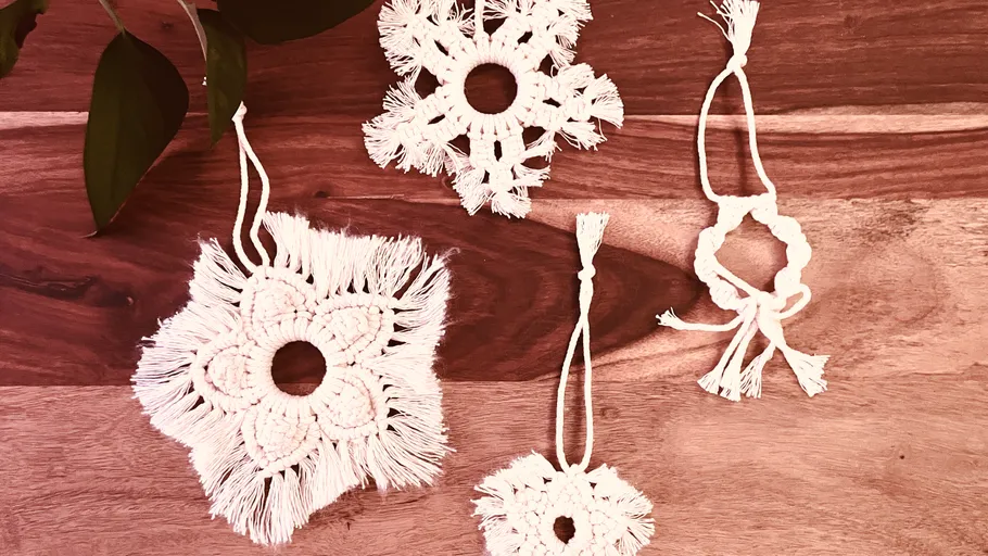 White crochet ornaments lie on a wooden background.