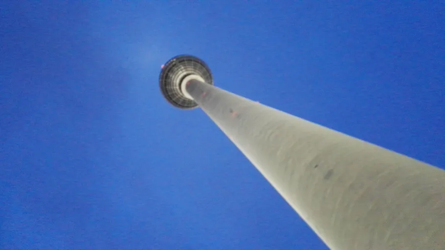 Tall tower viewed from below, blue sky.