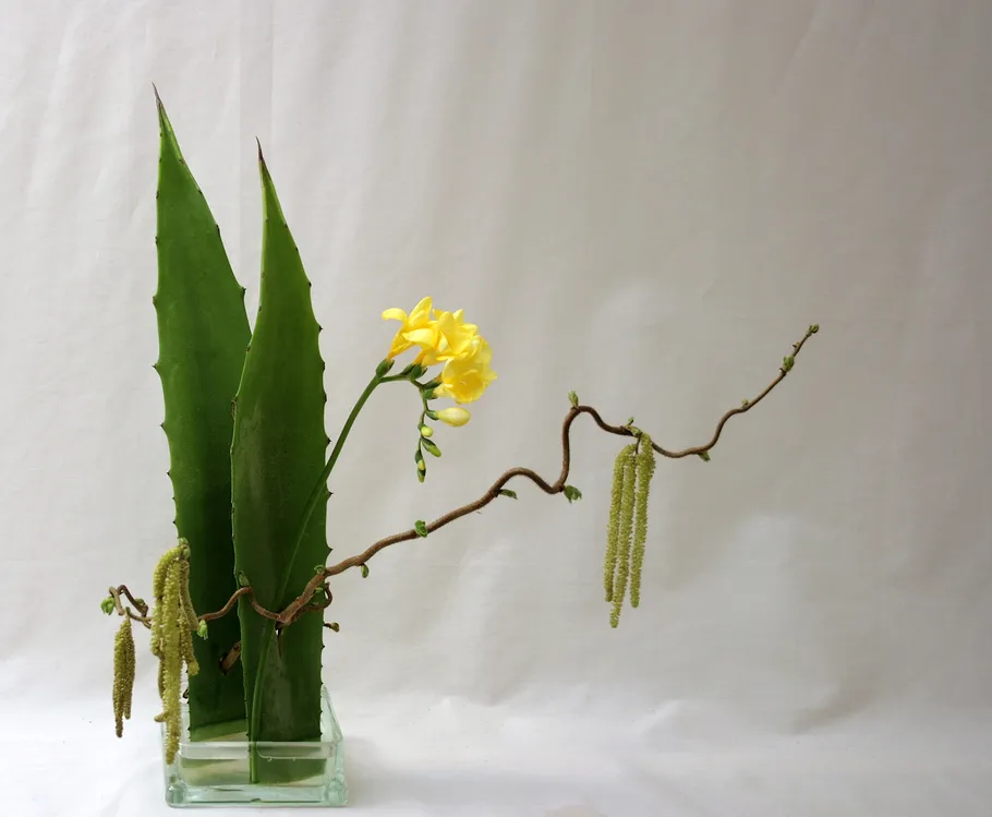 Floral arrangement with branches in a vase.