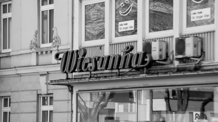 Building facade with Wiesanha sign and windows.
