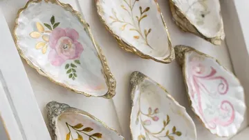Decorative painted oyster shells on display.