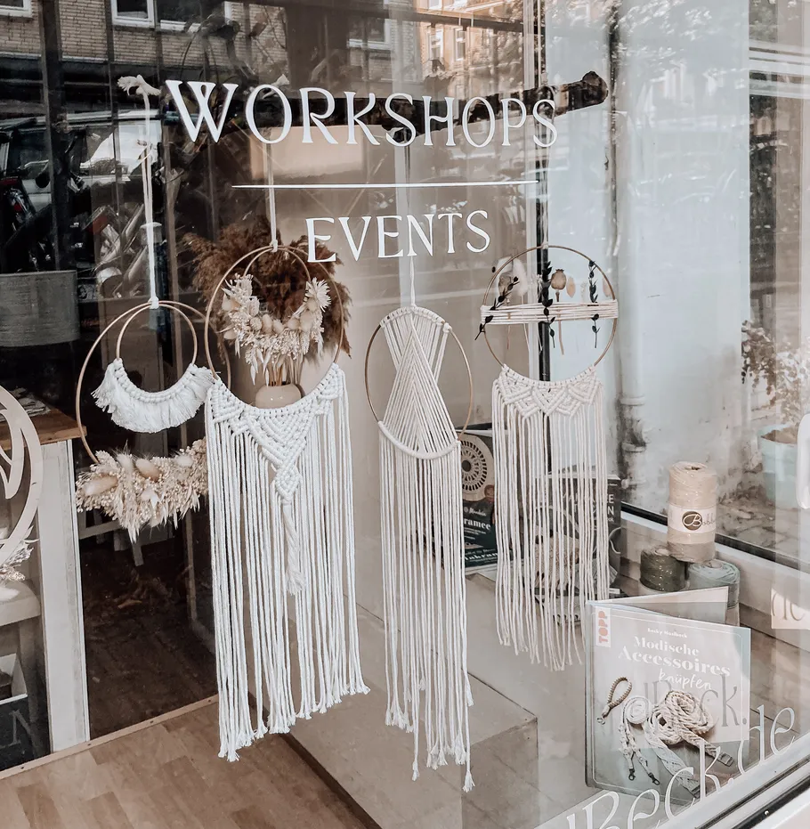 Macramé hangings displayed in shop window.