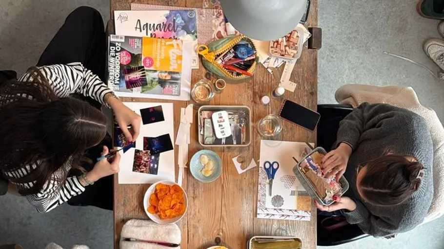 Two people crafting at a table.