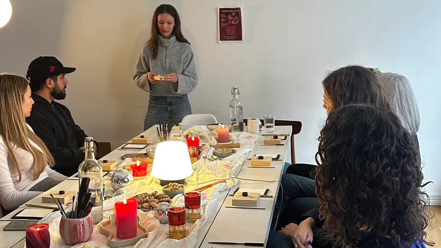 People sitting at a candlelit table listening.