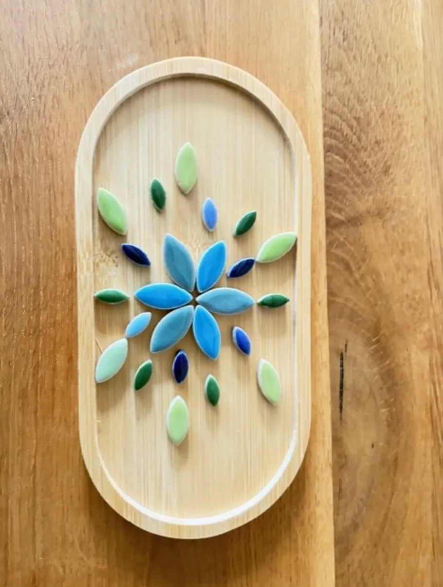 Colorful stone pattern on wooden tray.