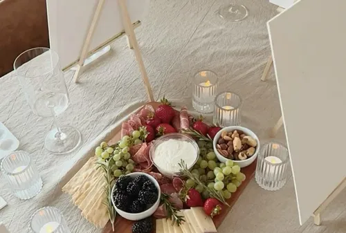 Charcuterie board with fruits and nuts on table.
