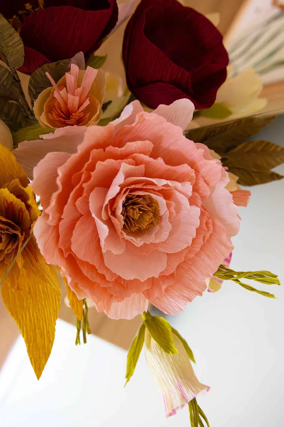 Paper flowers in a bright indoor setting.