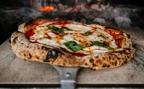 Pizza baking in a wood-fired oven.