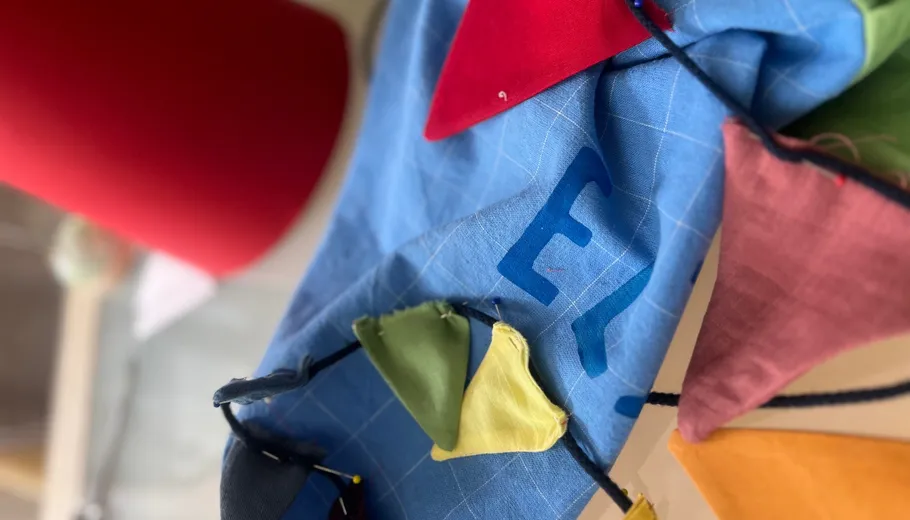 Colorful fabric triangles on blue cloth.