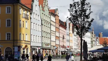 Colorful historic buildings line a bustling street.