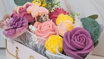 Colorful soap flowers in a pink box.