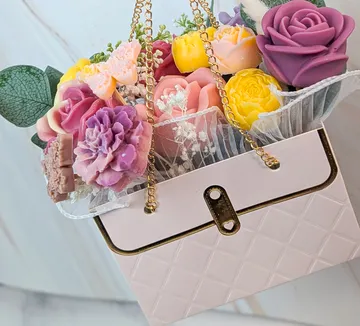 Soap flowers arranged in a handbag.