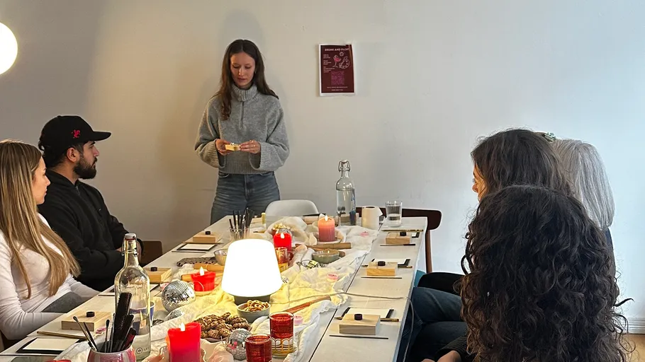 People seated at a table with candles.