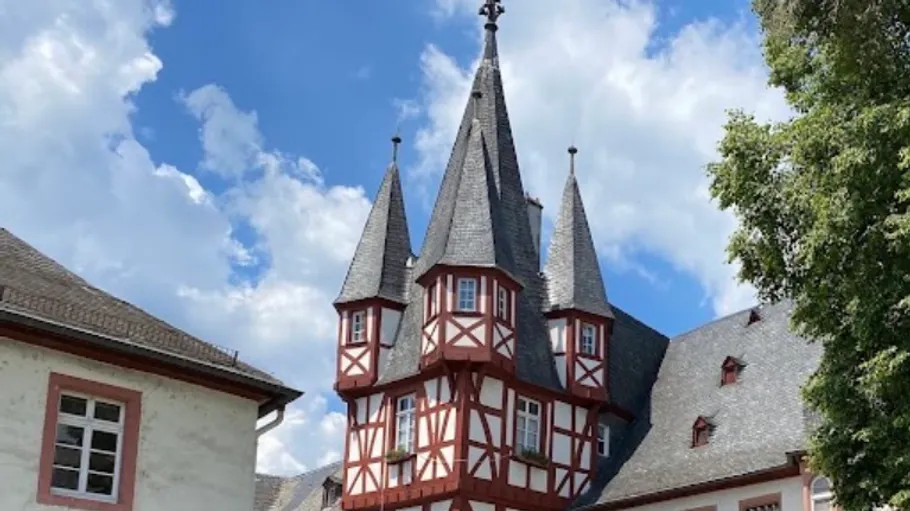 Medieval building with towers under blue sky.