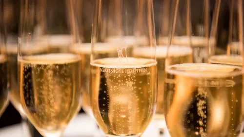 Glasses of champagne with bubbles in celebration.