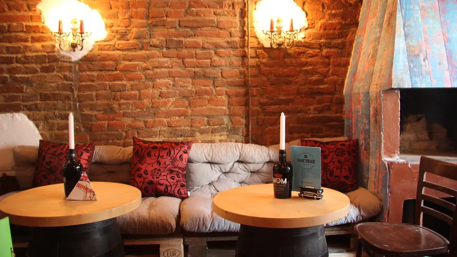 Cozy seating area with brick wall and candles.