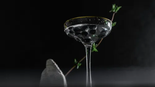 Glass of blueberries with dark background.