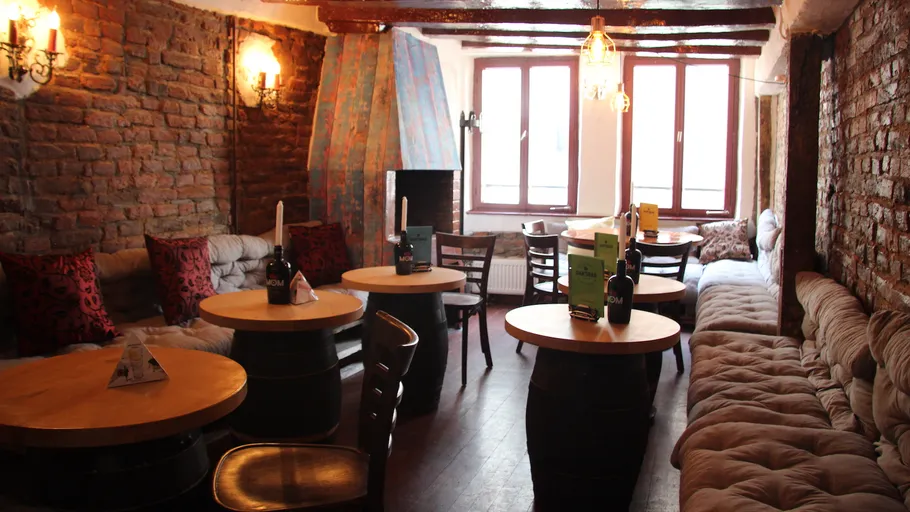 Gemütliches Pub-Interieur mit Backsteinwänden, Holztischen.