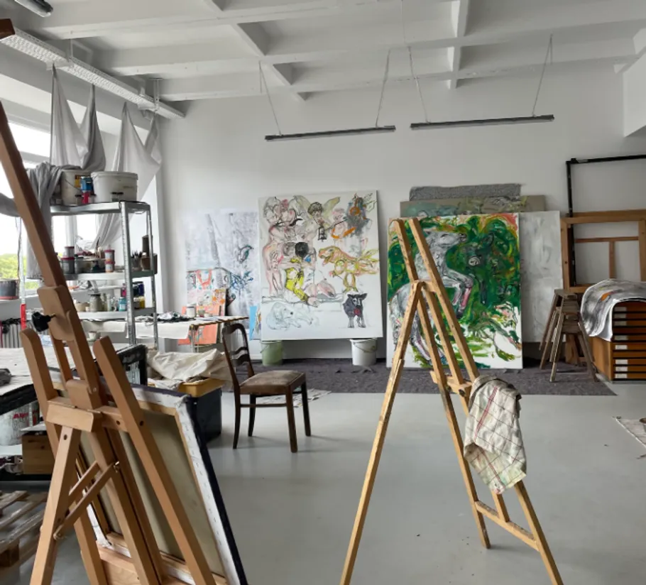 Art studio with paintings and easels.